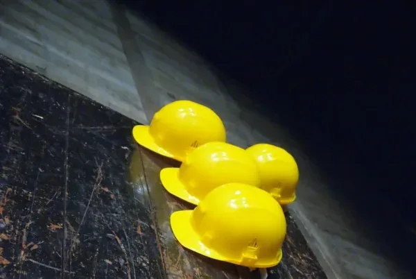 Photo by Silvia Brazzoduro five yellow hard hats on gray surface